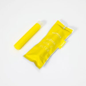 Yellow aroma diffuser filter in packaging with text “Aromica Aromatherapy Vital C Filter” on white background.