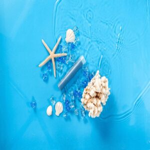 Starfish and seashells with filter cartridge on blue water background, representing pool and water filters for clean swimming environments, top-quality filter solutions from filterplace.eu.