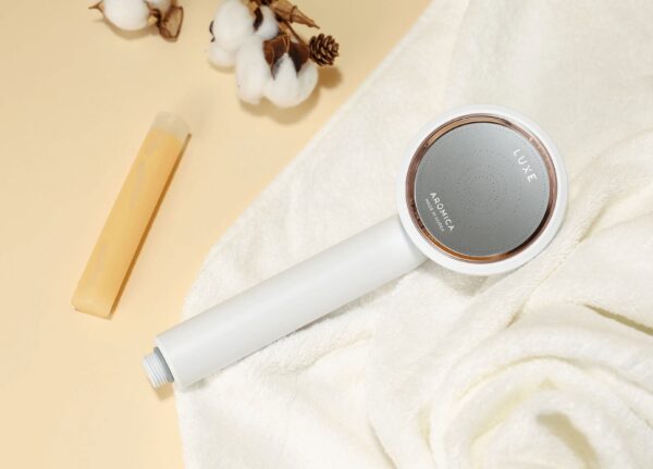 Air purifier with modern design, white cylindrical body and circular diffuser, placed on soft white towel, promoting clean air and well-being.